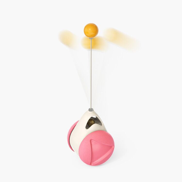 Pink and white toy with a yellow ball on a white background