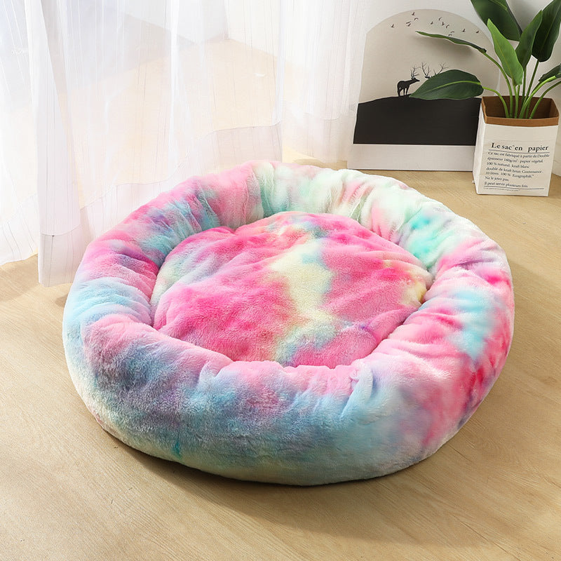 Multicolored tie-dye pet bed on a wooden floor with a light background