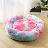 Multicolored tie-dye pet bed on a wooden floor with a light background