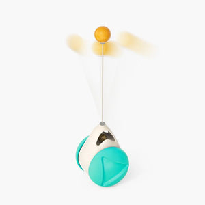 Pink and white toy with a yellow ball on a white background